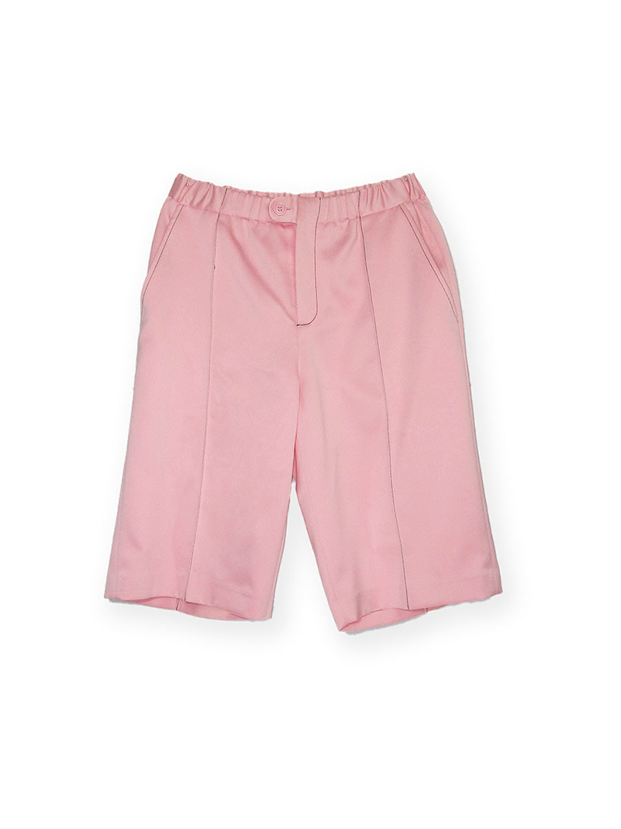 BOTANY SHORT | POWDER PINK, crafted from heavyweight satin for superior quality and crafted with contrast stitching coordinates with the BOTANY Shirt. This design is below-the-knee length for a unique and elegant look. Elevate your look with this luxurious piece. Over-sized fit Fly front Contrast Stitching Below the knee